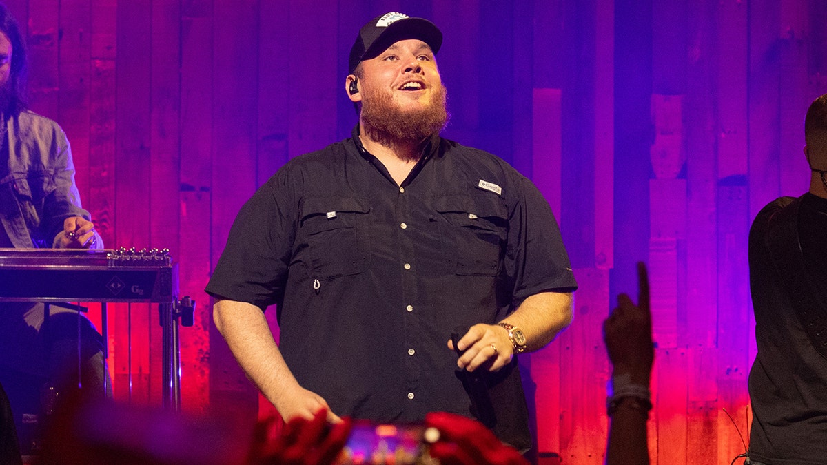 Luke Combs smiling on stage