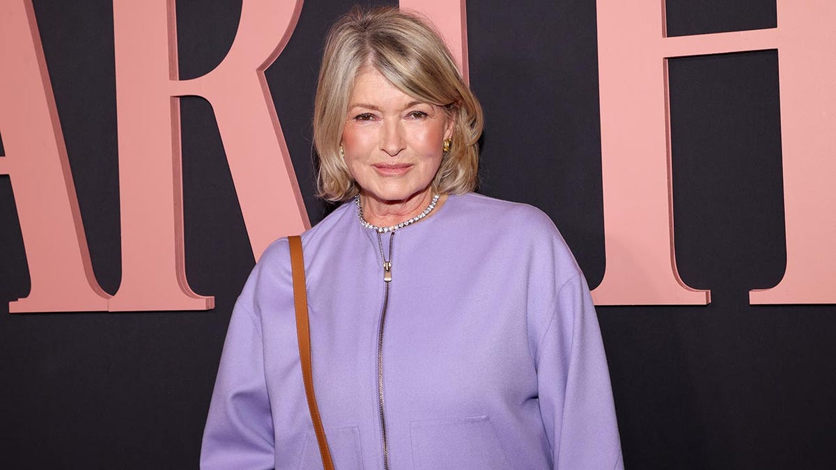 Martha Stewart successful  a lavender overgarment   brushed  smiles connected  the carpet astatine  her documentary premiere