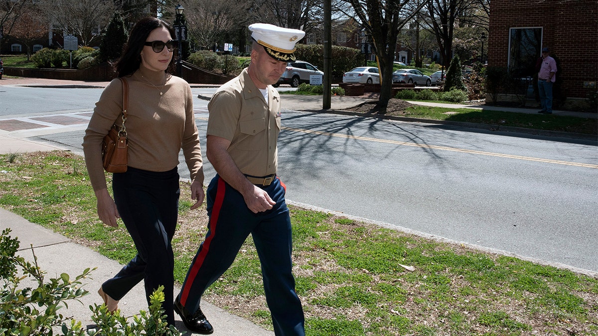 Marine Maj. Mast walking to tribunal  with his wife.