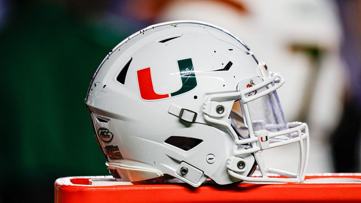 A Miami Hurricanes helmet connected  the sidelines