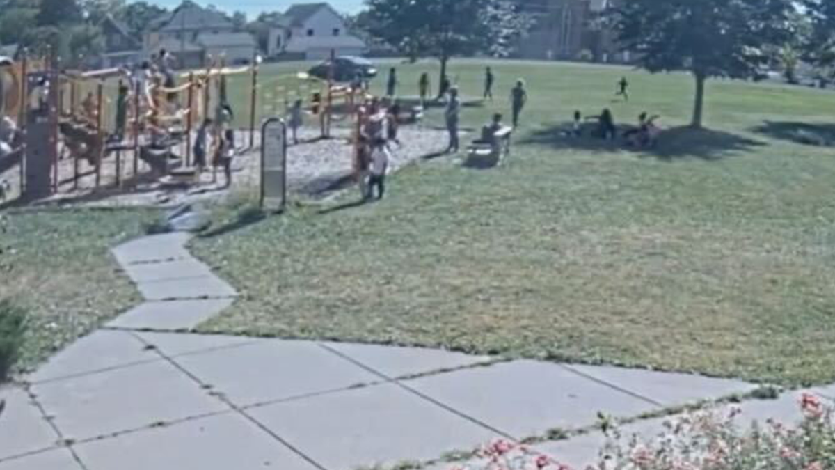 Child drives car near a playground