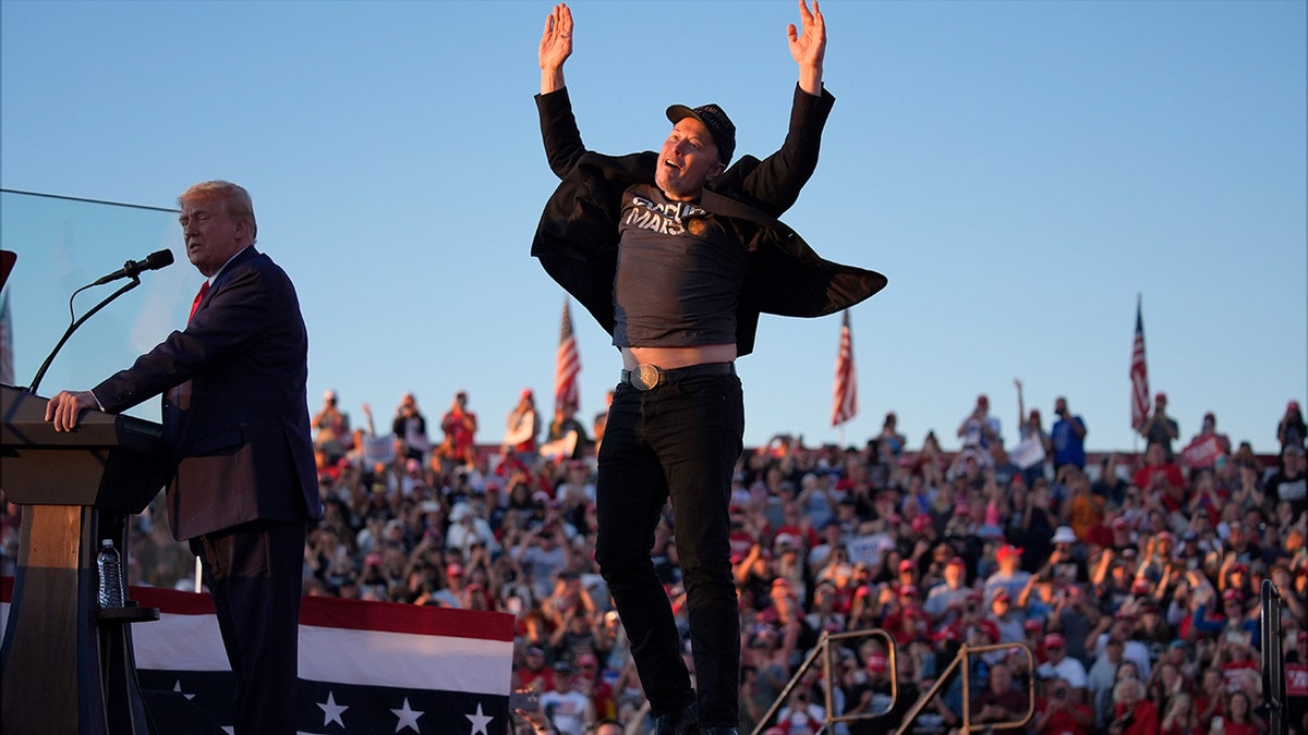 Elon Musk jumps in the air at a Trump rally