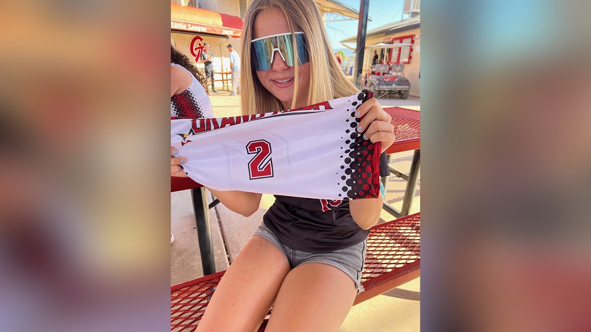 Kamberlyn Bowler holds softball jersey