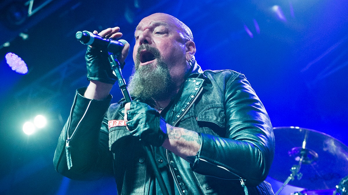 Close up of Paul Di'Anno singing into microphone.