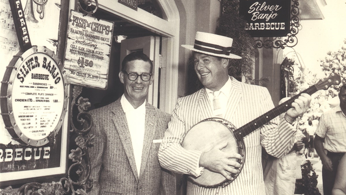 Don DeFore playing a banjo.