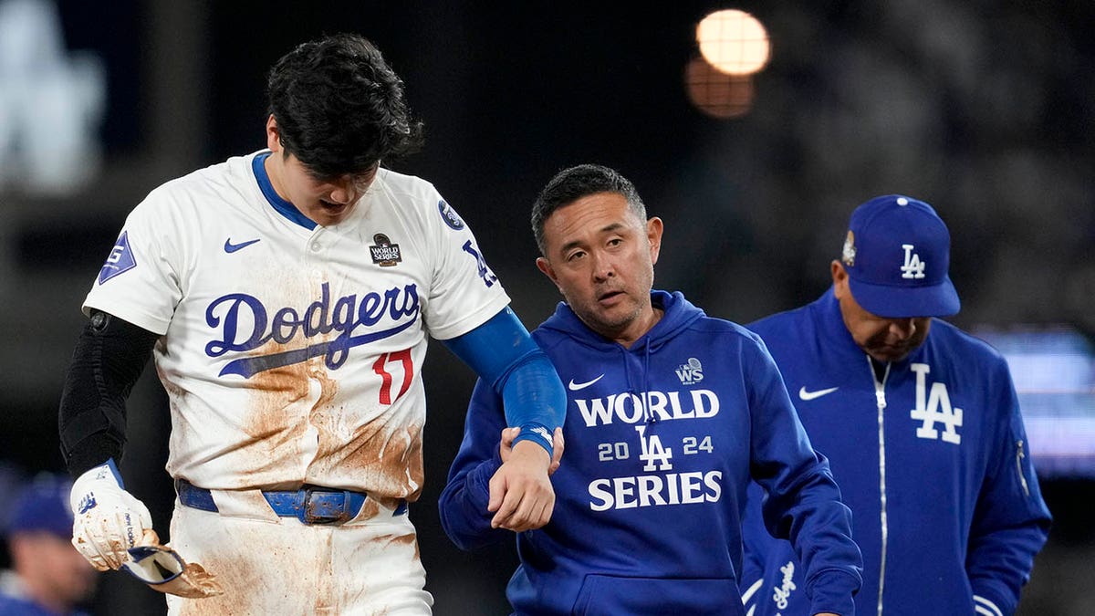 Shohei Ohtani helped off