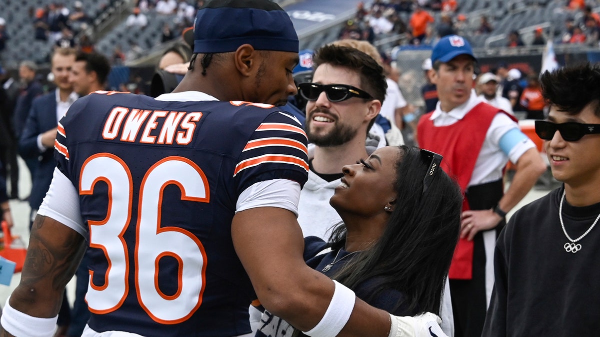 Simone Biles and Jonathan Owens before the Bears game