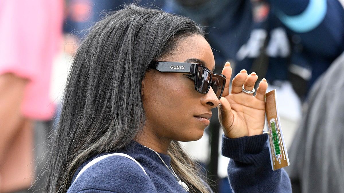 Simone Biles goes onto the field