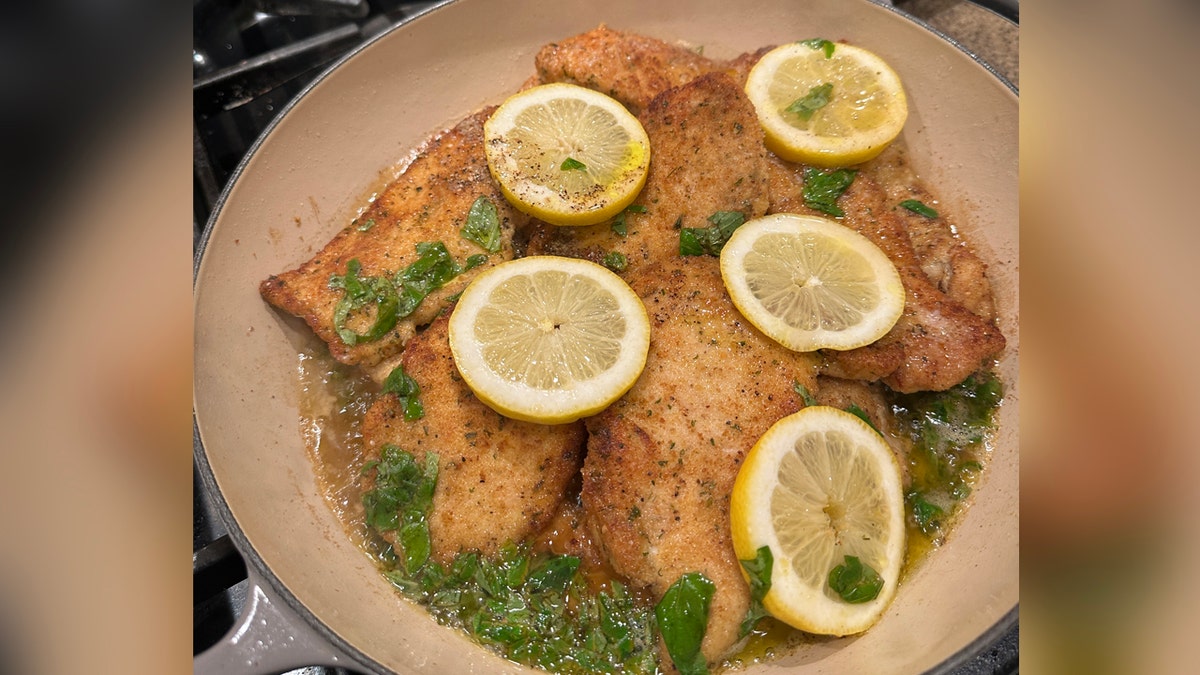 A chickenhearted  crockery  successful  a skillet with sliced lemons and basil.