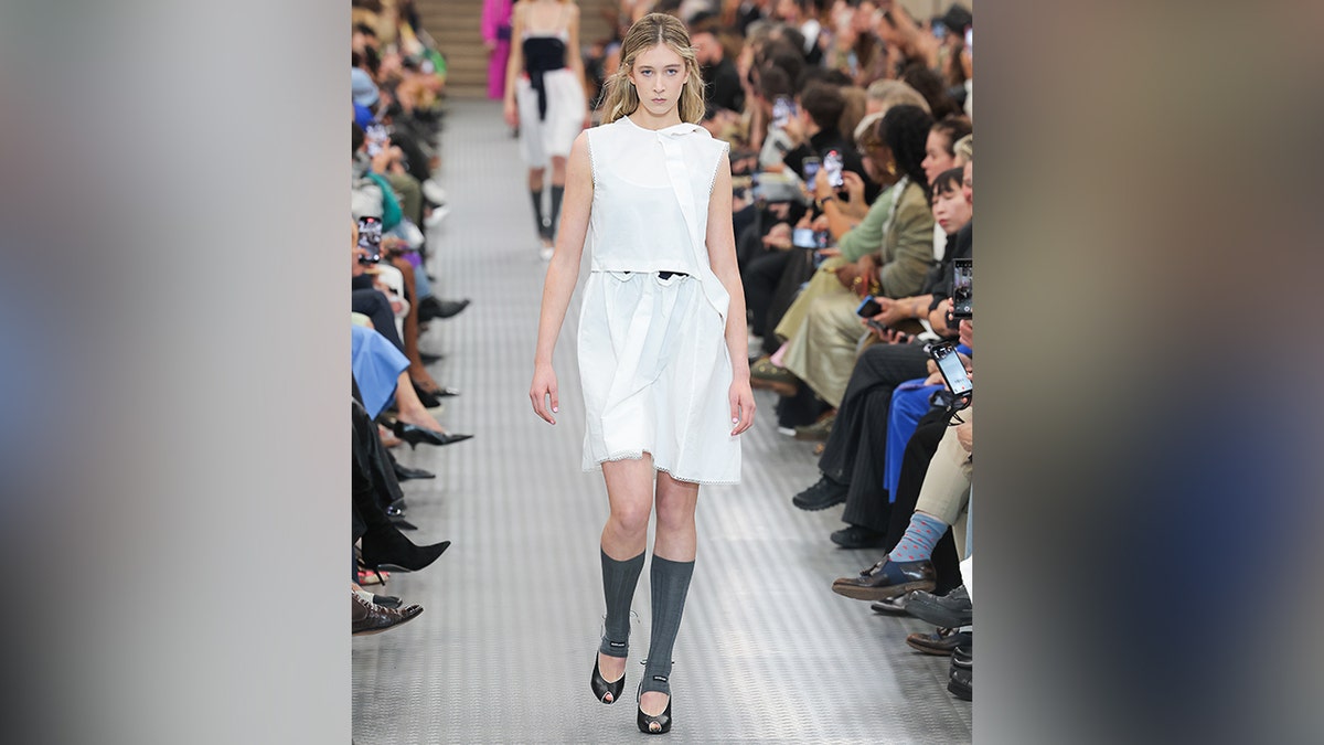 Sunday wore a white dress on the runway while walking for Miu Miu.