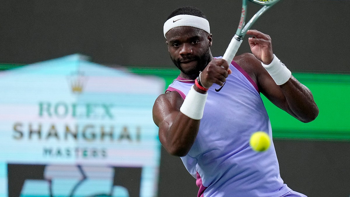 Frances Tiafoe returns a shot