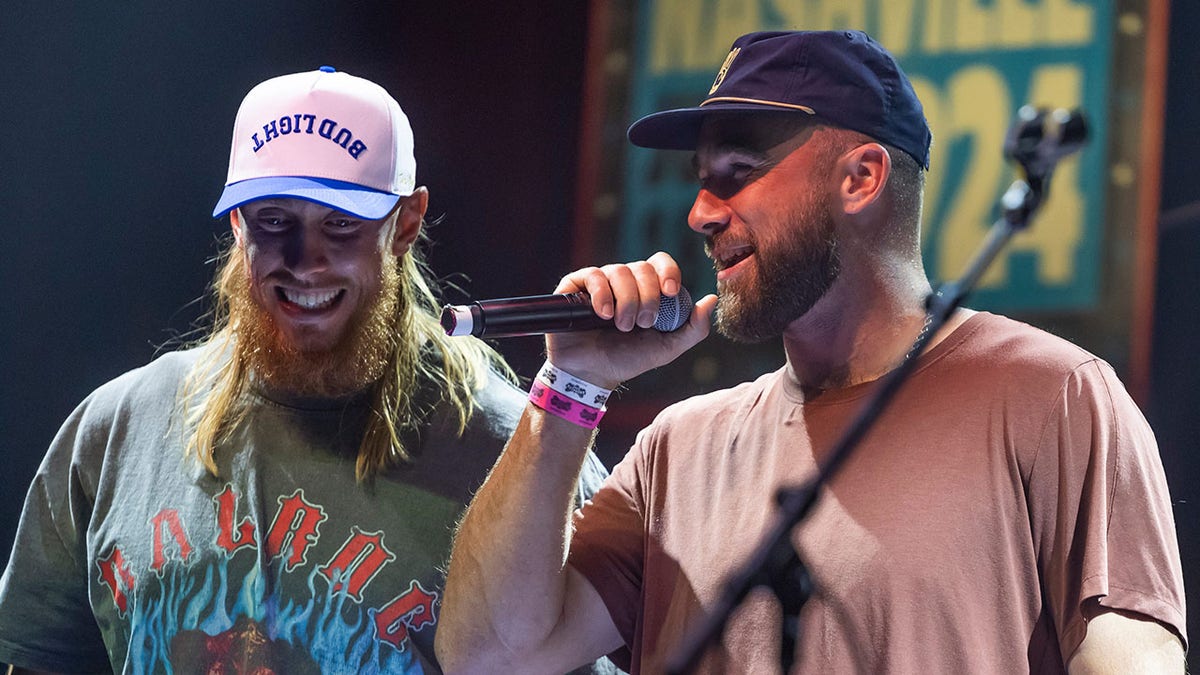 George Kittle and Travis Kelce greet an assemblage  