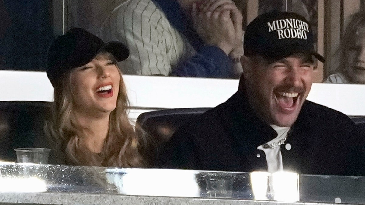 Travis Kelce and Taylor Swift laugh during Game 1 of the Baseball AL Championship Series between the Cleveland Guardians and the New York Yankees on Monday, October 14, 2024 in New York City.