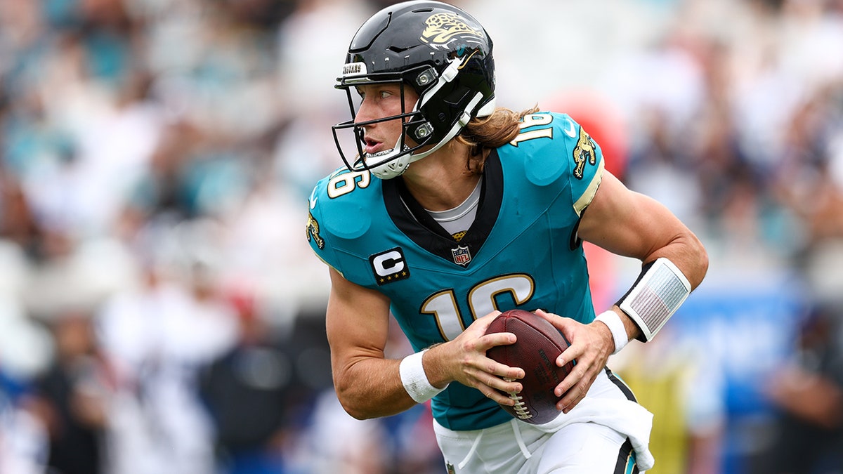 Trevor Lawrence runs with the ball