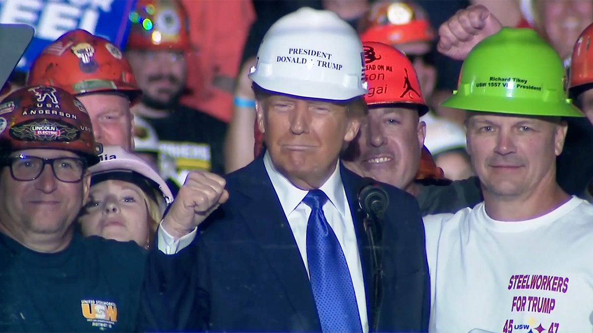 Donald Trump wears a protective helmet