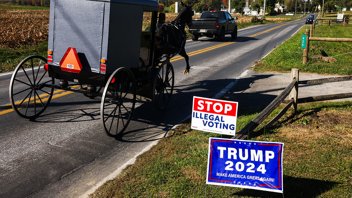 horse and buggy pass by Trump road signs