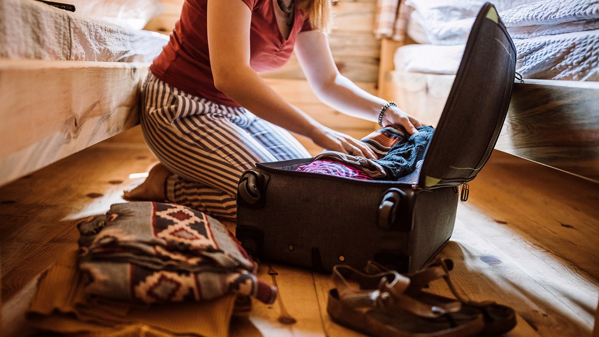 unpacking a bag of clothes after a trip