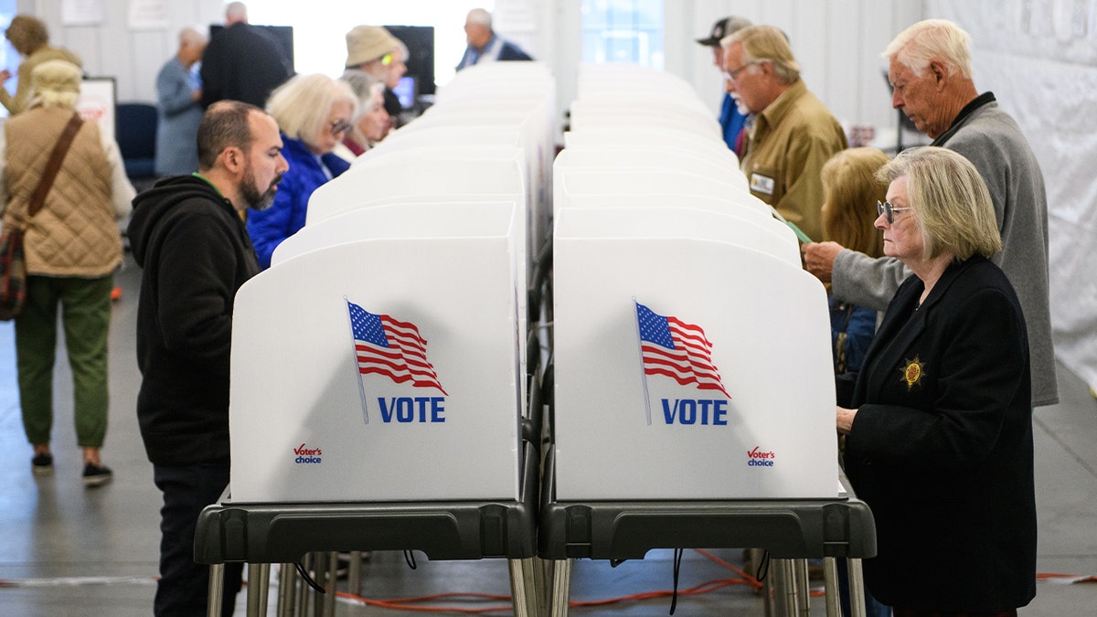 Voters make selections astatine their voting booths wrong an early voting tract connected Oct. 17, 2024 successful Hendersonville, North Carolina. Several counties affected by Hurricane Helene saw a ample turnout of residents for nan first time of early voting successful occidental North Carolina.