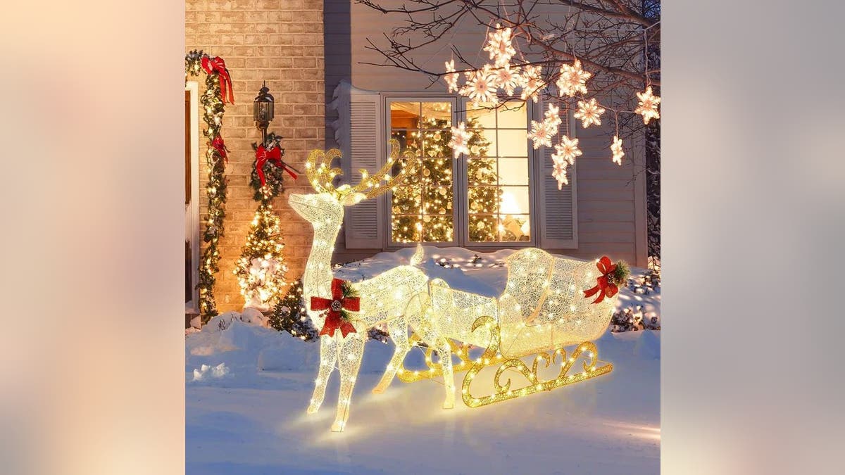 This pre-lit reindeer and Santa's sleigh decoration acceptable   brings the wow factor.