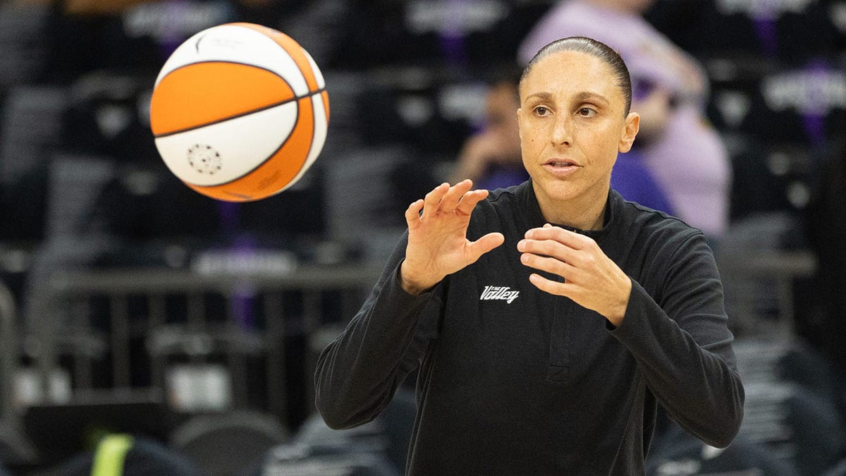 Diana Taurasi catches the basketball