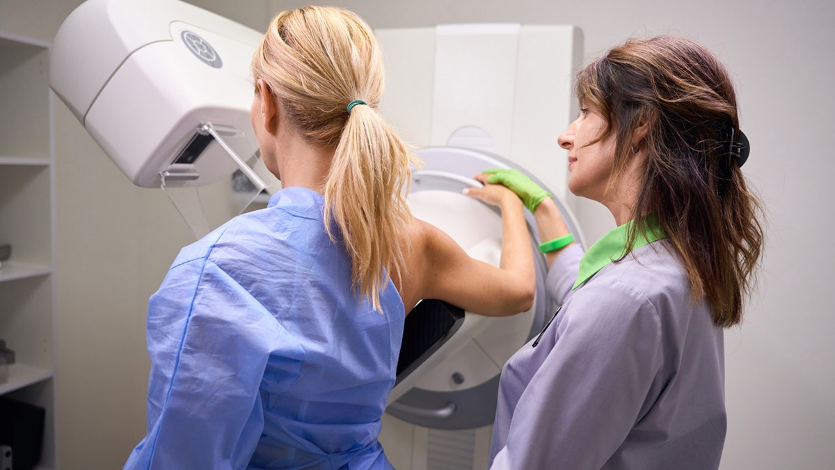 A woman at the doctors getting her mammogram 