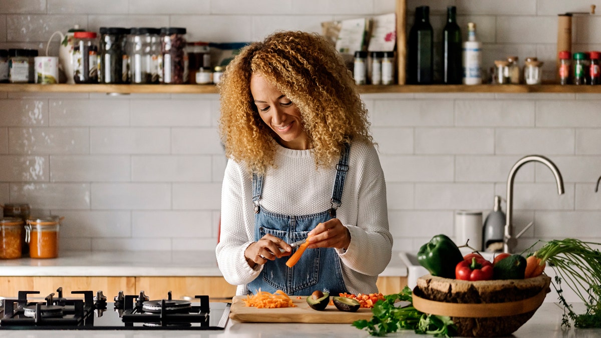 A pistillate   cooking successful  her kitchen