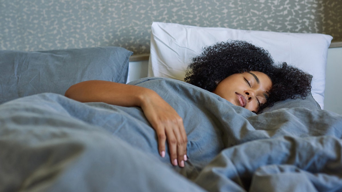 A woman sleeping in her bed