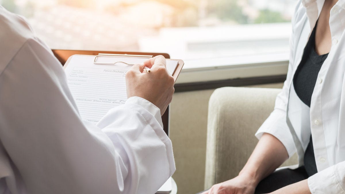 Woman talking to doctor