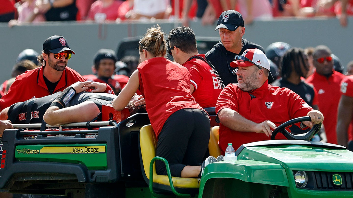 Spine-Chilling Moment: NC State Quarterback Grayson McCall Carted Off After Vicious Hit