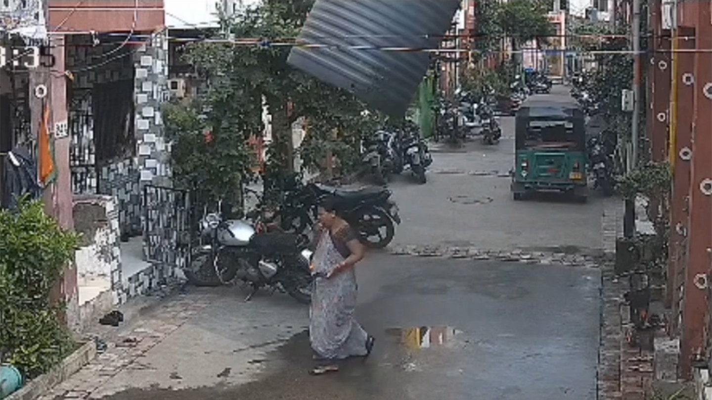 Woman in India Miraculously Escapes Injury After Water Tank Falls Perfectly Around Her