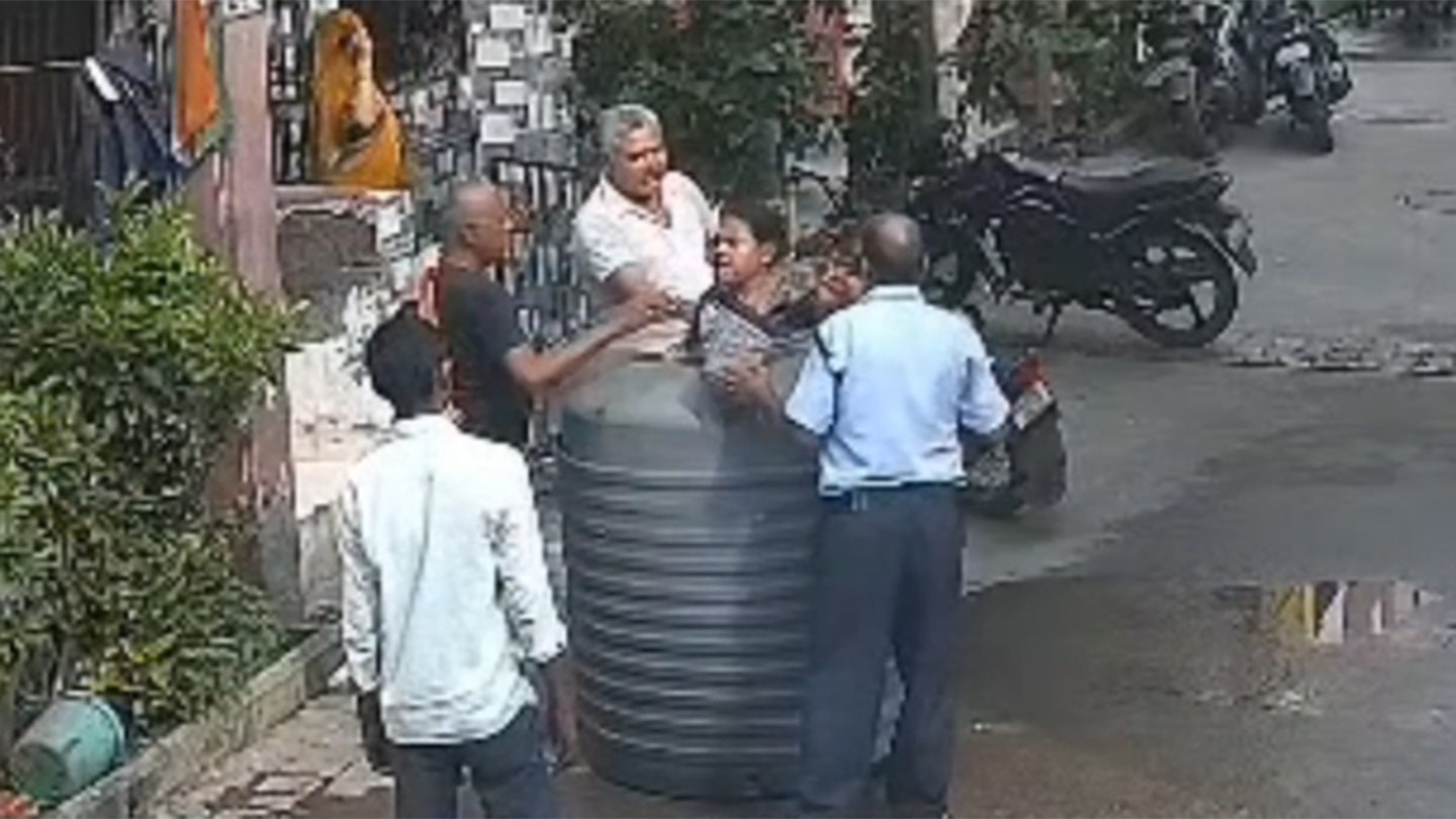 Woman in India Miraculously Escapes Injury After Water Tank Falls Perfectly Around Her