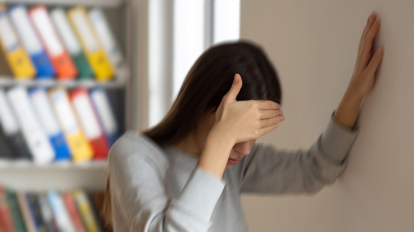 woman holding head