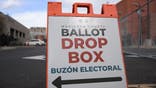 Signage directs voters to a ballot drop box for early voting outside of the Maricopa County Tabulation and Election Center ahead of the Arizona midterm elections in Phoenix, Arizona on November 3, 2022. (Photo by Patrick T. FALLON / AFP) (Photo by PATRICK T. FALLON/AFP via Getty Images)