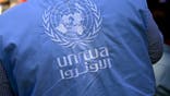 The UNRWA logo is seen on the vest of an employee during a visit to the Jabal El Hussein refugee camp of UNRWA (United Nations Relief and Works Agency for Palestine Refugees in the near East), part of a diplomatic mission to Israel and the Palestinian territories, in Amman, Jordan, Wednesday 15 May 2024.