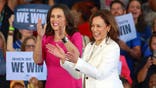 DETROIT, MICHIGAN - AUGUST 7: US Vice President and Democratic presidential candidate Kamala Harris (R) and Michigan Gov. Gretchen Whitmer (L) stand together on the stage surrounded by supporters campaign rally at the Detroit Metropolitan Airport in Romulus, Michigan, August 7, 2024. (Photo by Amy Lemus/NurPhoto via Getty Images)
