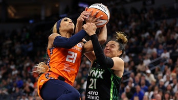 Sun's DiJonai Carrington held back by teammate after hard foul vs Lynx