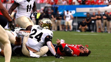 NC State quarterback Carted off the field after scary hit sends helmet flying 