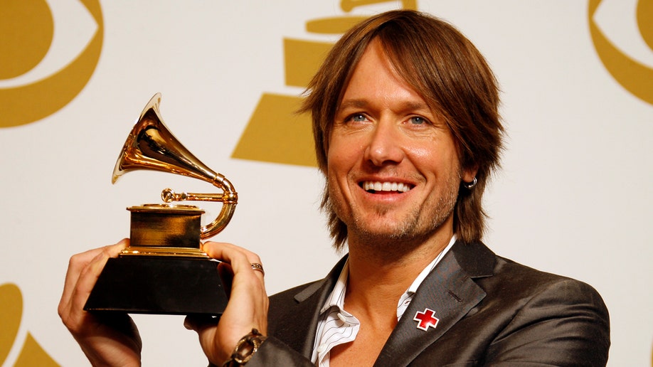 Keith Urban holding up   Grammy Award