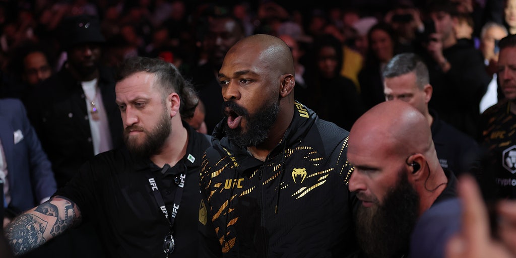 Jon 'Bones' Jones performs Donald Trump's famous dance, gives title belt to president-elect after TKO victory