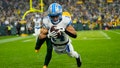 Detroit Lions wide receiver Amon-Ra St. Brown (14) catches a pass in front of Green Bay Packers cornerback Keisean Nixon (25) to score a touchdown during the second quarter at Lambeau Field. - Fox News