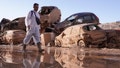 A man walks past stacked up cars after floods in Catarroja that left hundreds dead or missing in the Valencia region in Spain, Tuesday, Nov. 12, 2024. - Fox News