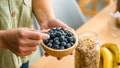 Woman eating organic blueberries from a bowl - Fox News