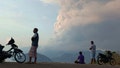 Residents watch as Mount Lewotobi Laki Laki volcano spews volcanic materials during an eruption in East Flores, Indonesia Saturday, Nov, 9, 2024. - Fox News