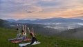 Fitness young women in sport clothes doing yoga exercises among green nature. Three ladies spending free time for outdoors training. - Fox News