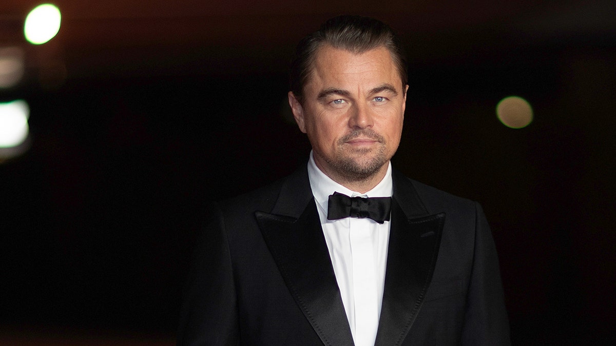 Leonardo DiCaprio doesnt smile, wearing a classic tuxedo on the carpet