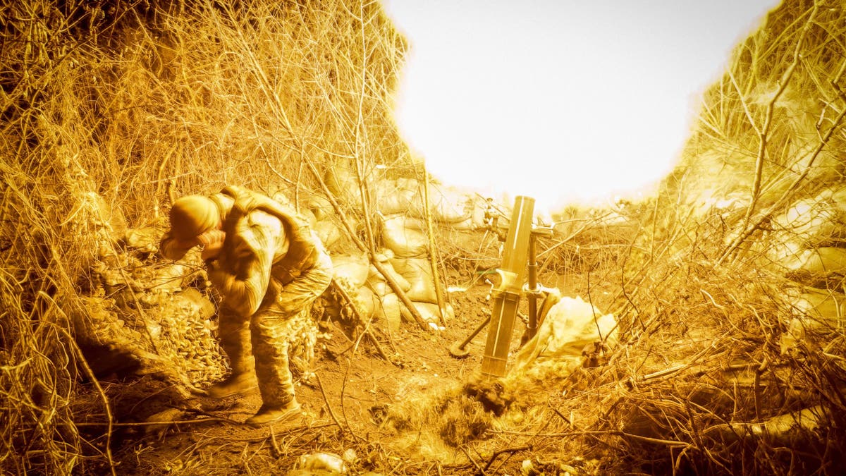 A serviceman of the 24th mechanized brigade named after King Danylo of the Ukrainian Armed Forces fires a 120-mm mortar towards Russian troops at a frontline, November 19, 2024.