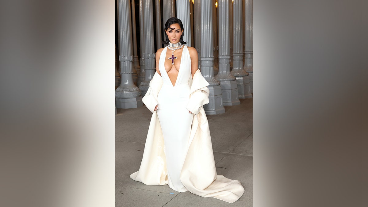 Kim Kardashian in a white dress with a deep plunging neckline