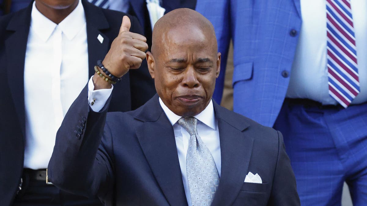 Adams gives a thumbs up outside the courthouse