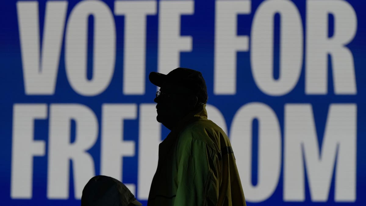 A participant waits at a campaign rally for Democratic vice presidential candidate Tim Walz of Minnesota, Monday, Nov. 4, 2024, in Detroit.