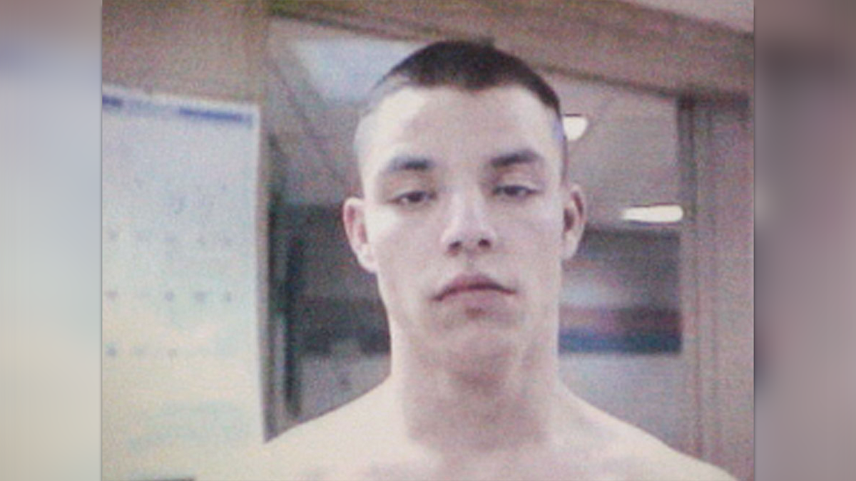 Brandon Basham with buzzed hair and shirtless in prison photo